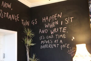 black wall with white chalk writing.